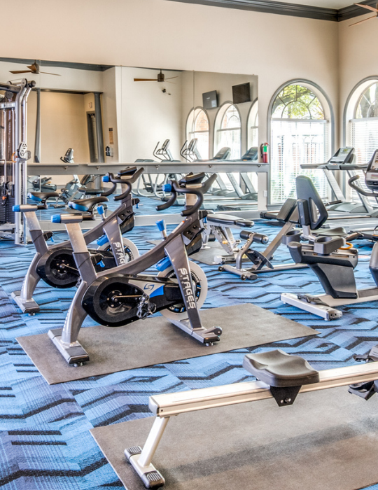 a gym room with exercise equipment and mirrors at The The Brixton